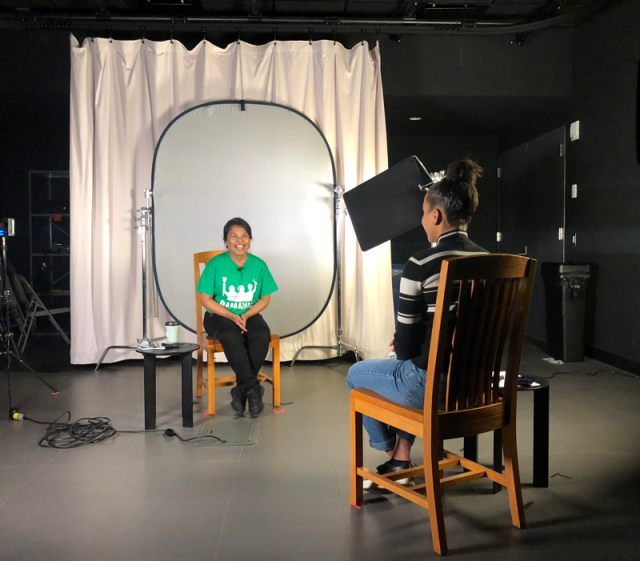 A student interviews a domestic worker in the Media Center Studio