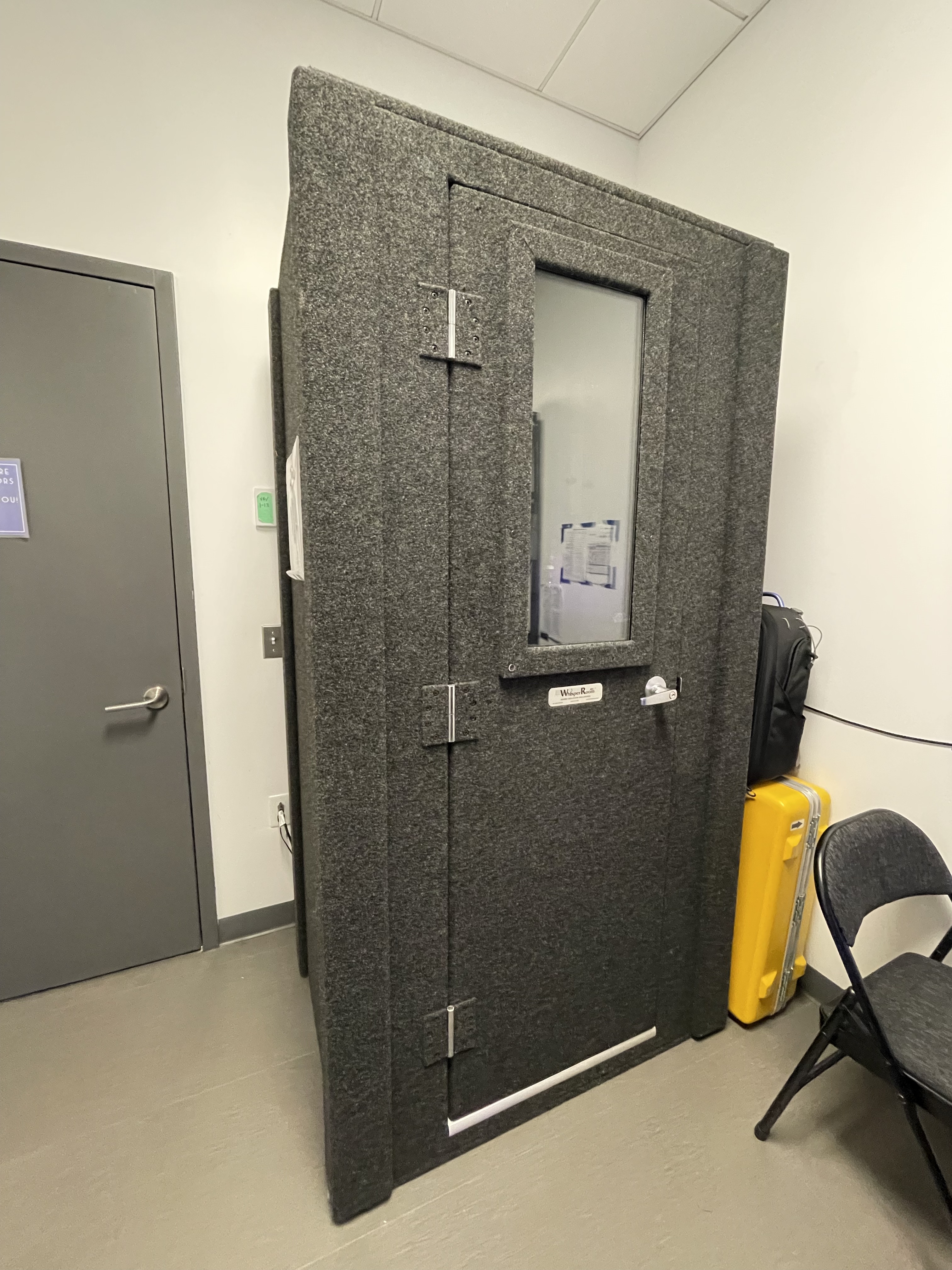 Single user-sized soft audio booth with gray sound insulation felt. Contains a rectangular window to peek inside.