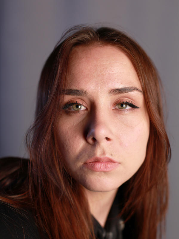 Young white woman with red-brown hair not smiling
