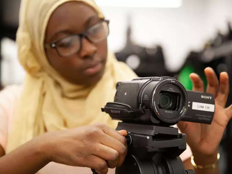 student using a basic camera