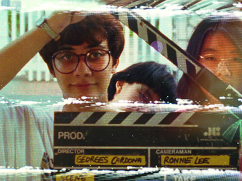 Young Asian person holding a clapperboard